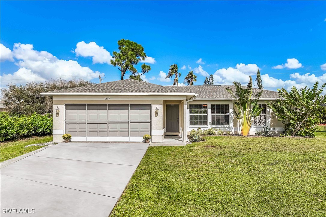 8457 Robin Road Fort Myers, FL 33967 - Photo 1 of 18 a front view of a house with a yard and garage