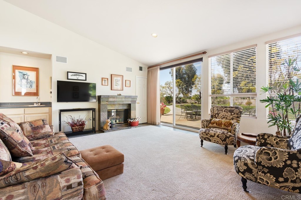 1667 Del Mar Road Oceanside, CA 92057 - Photo 18 of 51 a living room with furniture large window and a flat screen tv