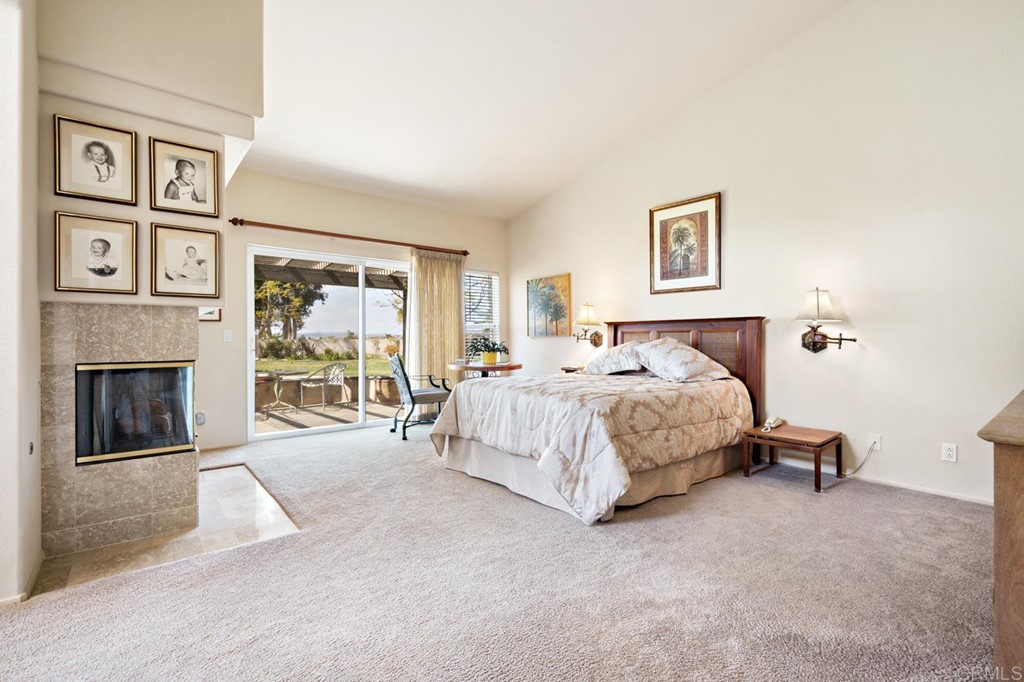 1667 Del Mar Road Oceanside, CA 92057 - Photo 22 of 51 a bedroom with a bed and a fireplace