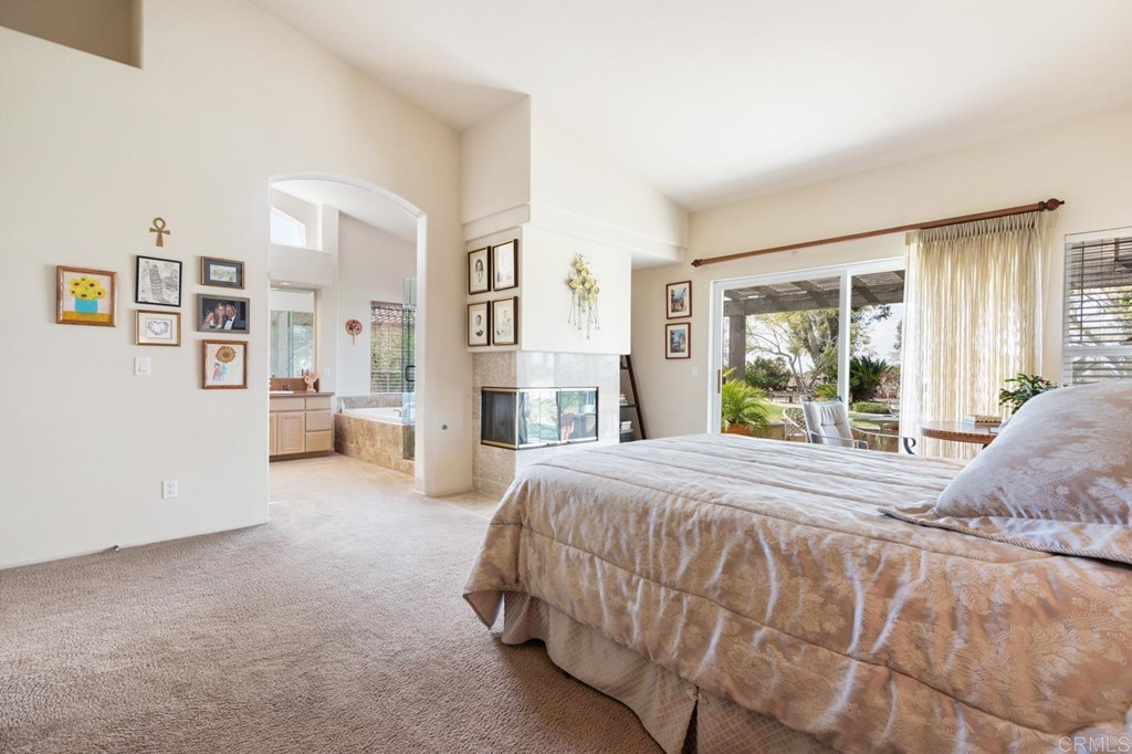 1667 Del Mar Road Oceanside, CA 92057 - Photo 23 of 51 a spacious bedroom with a bed couch and a window