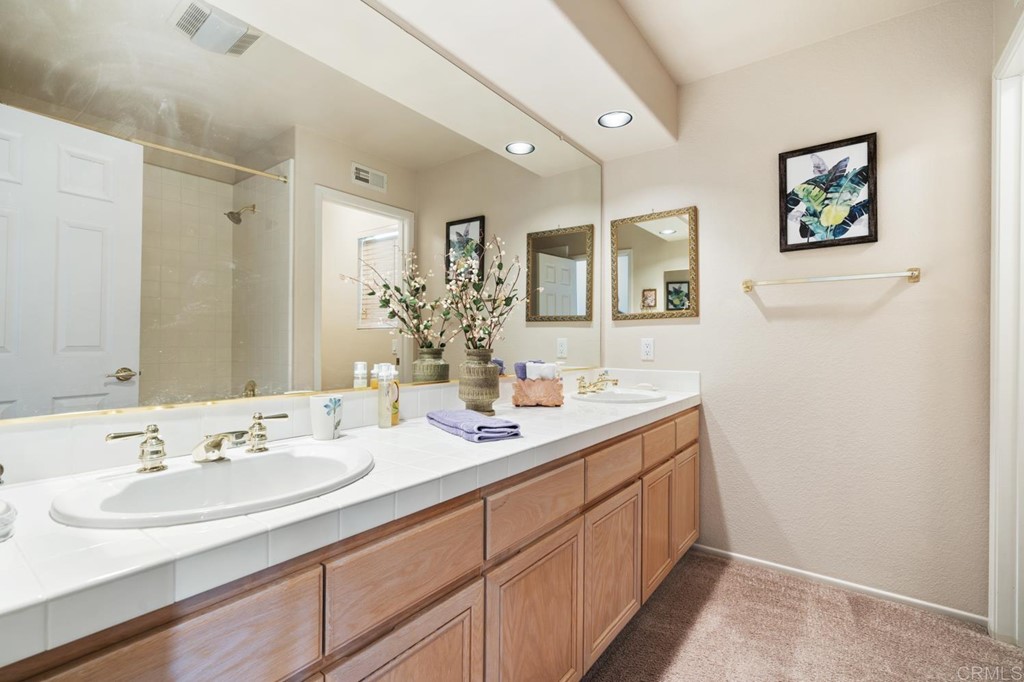 1667 Del Mar Road Oceanside, CA 92057 - Photo 27 of 51 a bathroom with a double vanity sink and a mirror