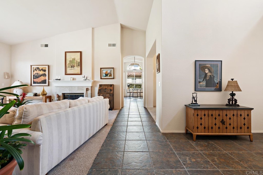 1667 Del Mar Road Oceanside, CA 92057 - Photo 10 of 51 a living room with furniture a baby crib and a wooden floor
