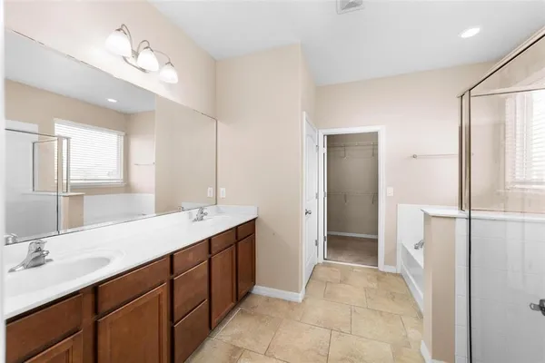 a bathroom with a double vanity sink a and mirror