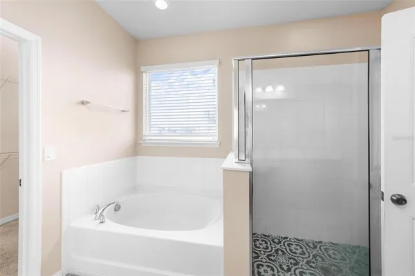 a bathroom with a bathtub and a shower