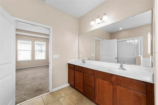 a bathroom with a double vanity sink and a mirror