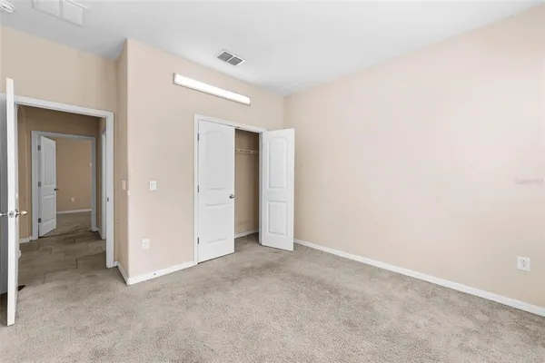 an empty room with closet area