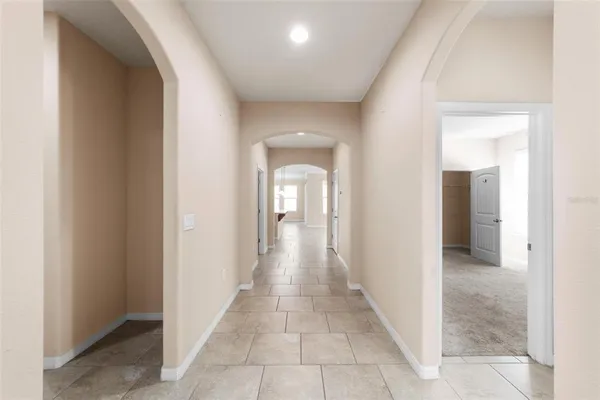 a view of a hallway with wooden shelves