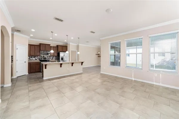 a view of kitchen with stainless steel appliances kitchen island refrigerator sink and cabinets