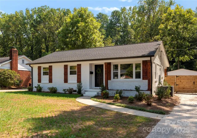 a front view of a house with a garden and patio