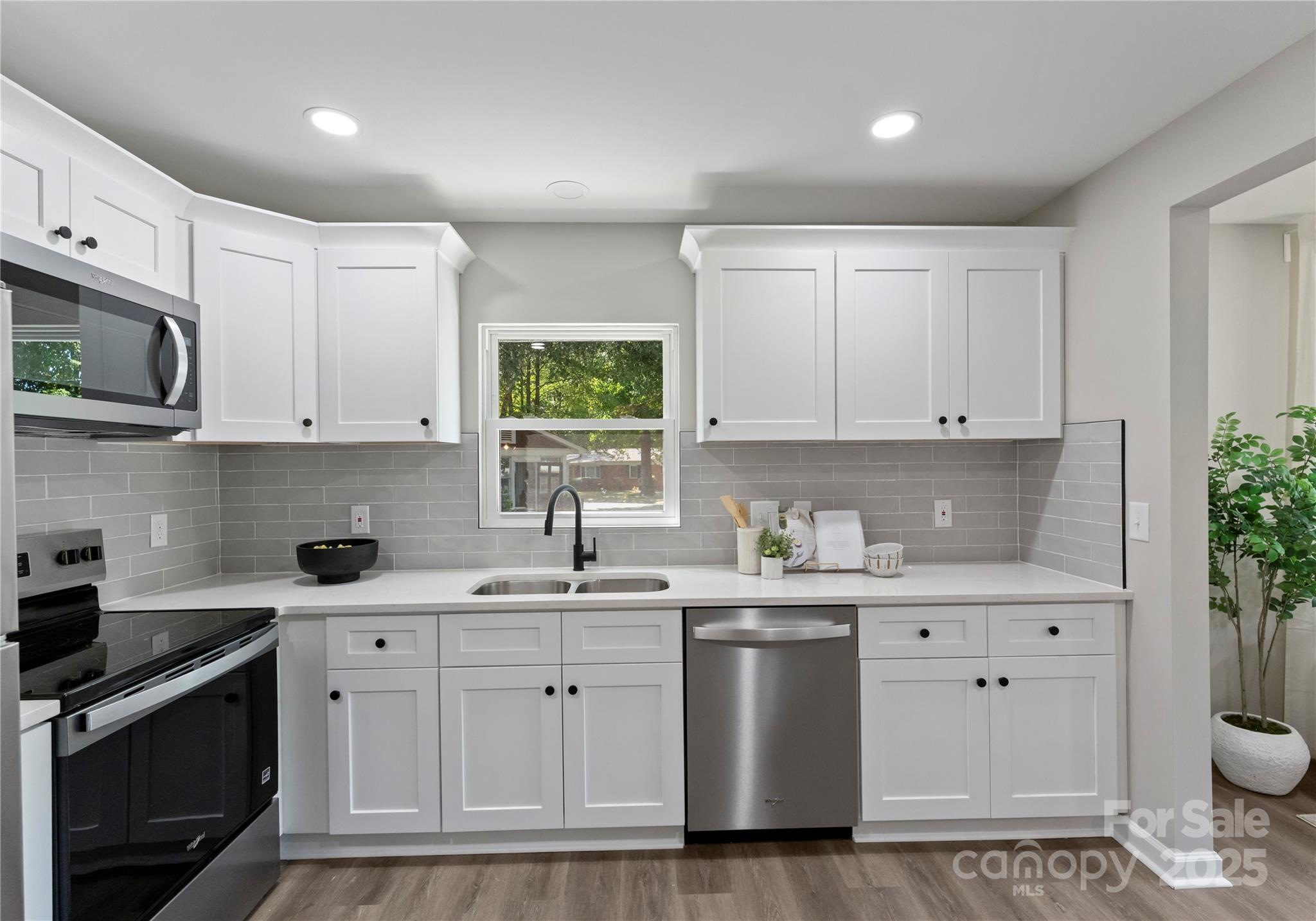 2900 Enfield Road Charlotte, NC 28205 - Photo 11 of 35 a kitchen with white cabinets stainless steel appliances and sink
