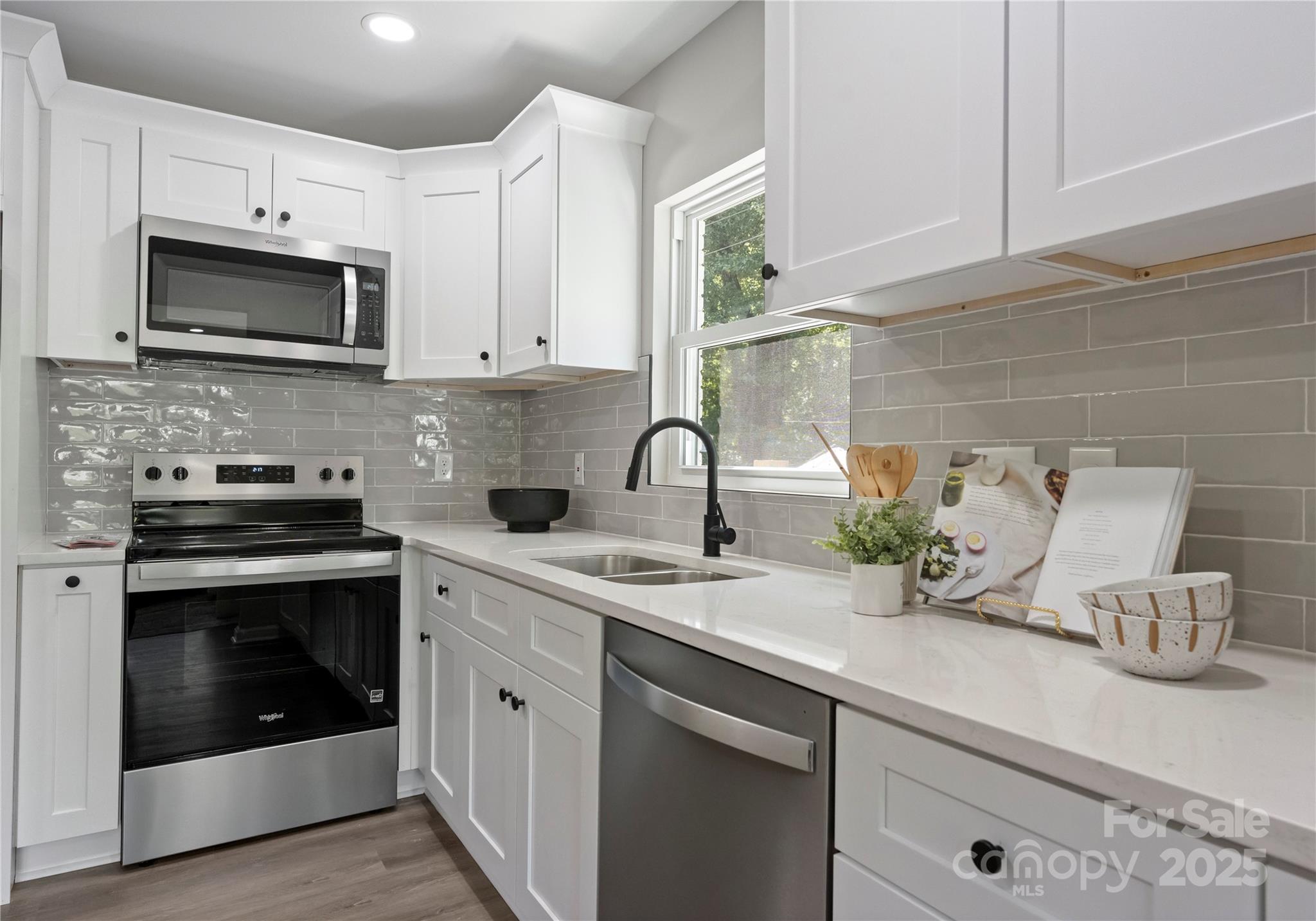 2900 Enfield Road Charlotte, NC 28205 - Photo 12 of 35 a kitchen with sink a microwave and cabinets