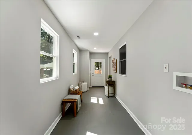 a hallway with furniture and window