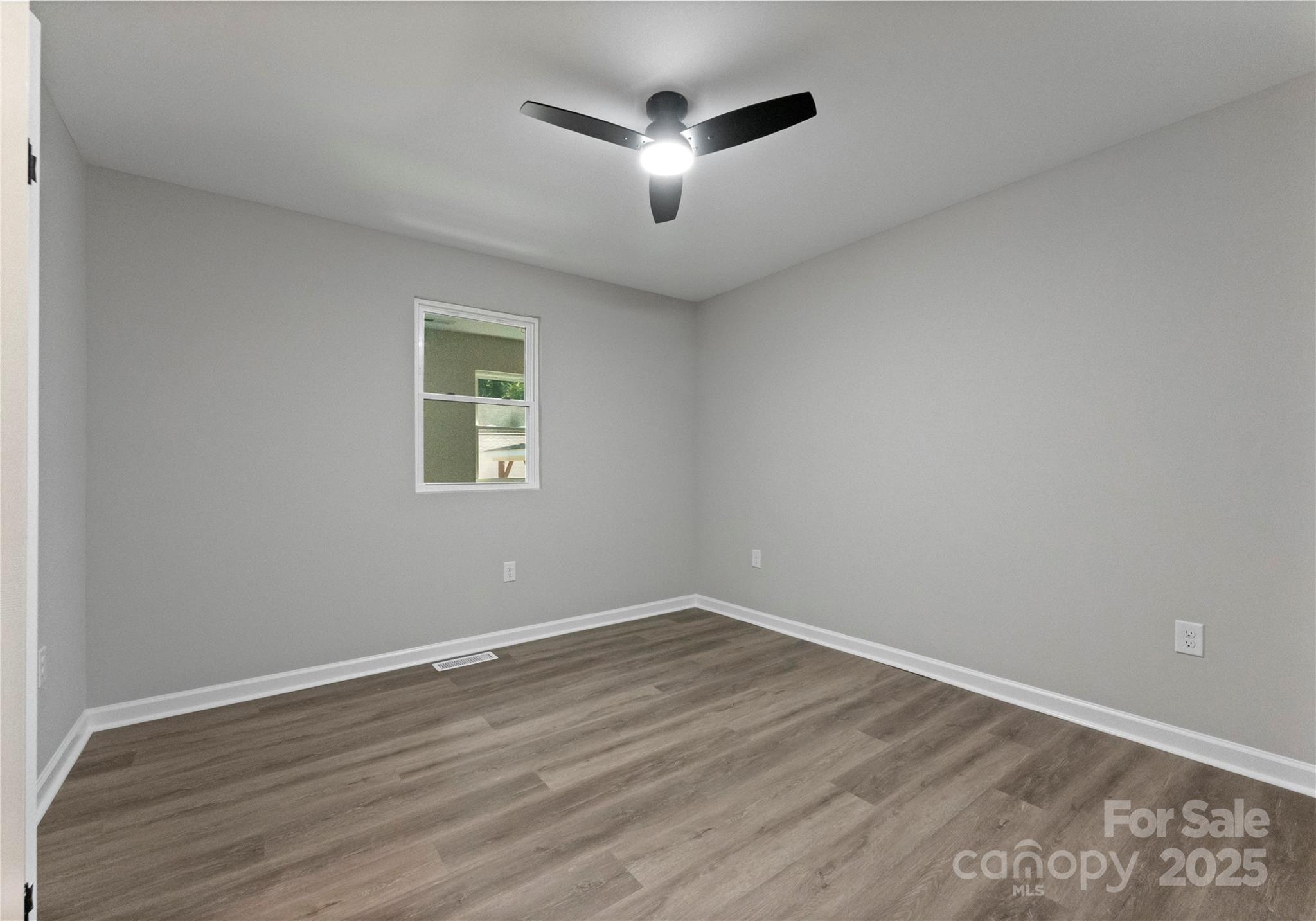 2900 Enfield Road Charlotte, NC 28205 - Photo 16 of 35 a view of a room with wooden floor and a ceiling fan