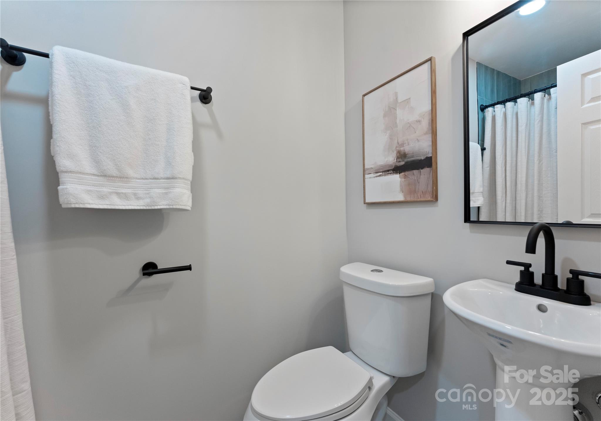 2900 Enfield Road Charlotte, NC 28205 - Photo 17 of 35 a white toilet sitting next to a bathroom sink