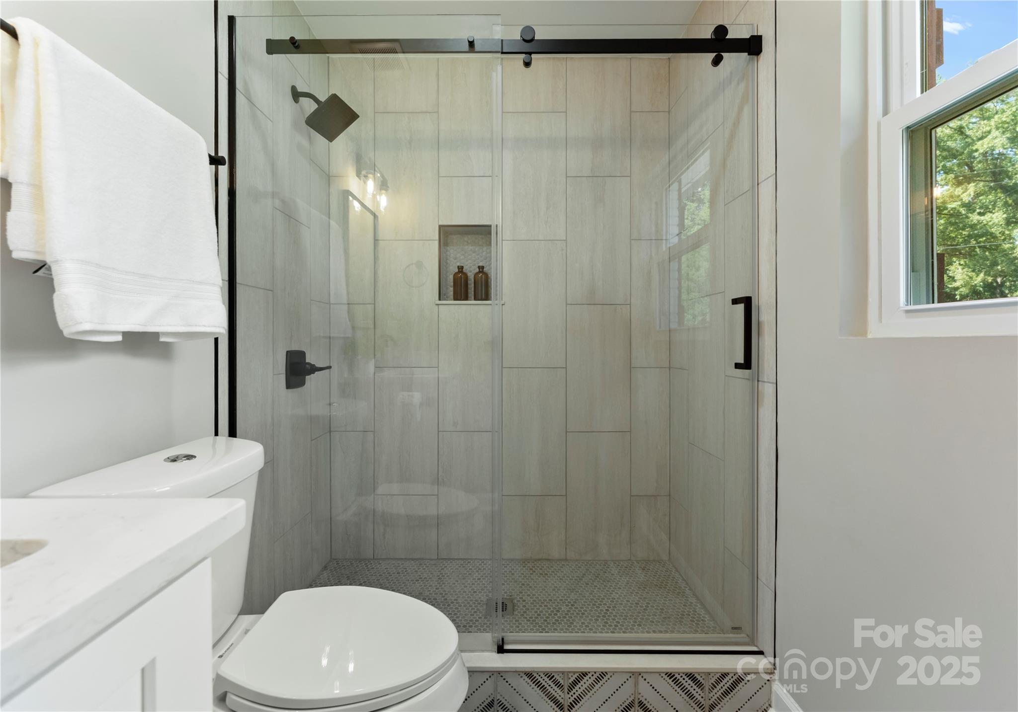 2900 Enfield Road Charlotte, NC 28205 - Photo 22 of 35 a bathroom with a shower a toilet and a sink