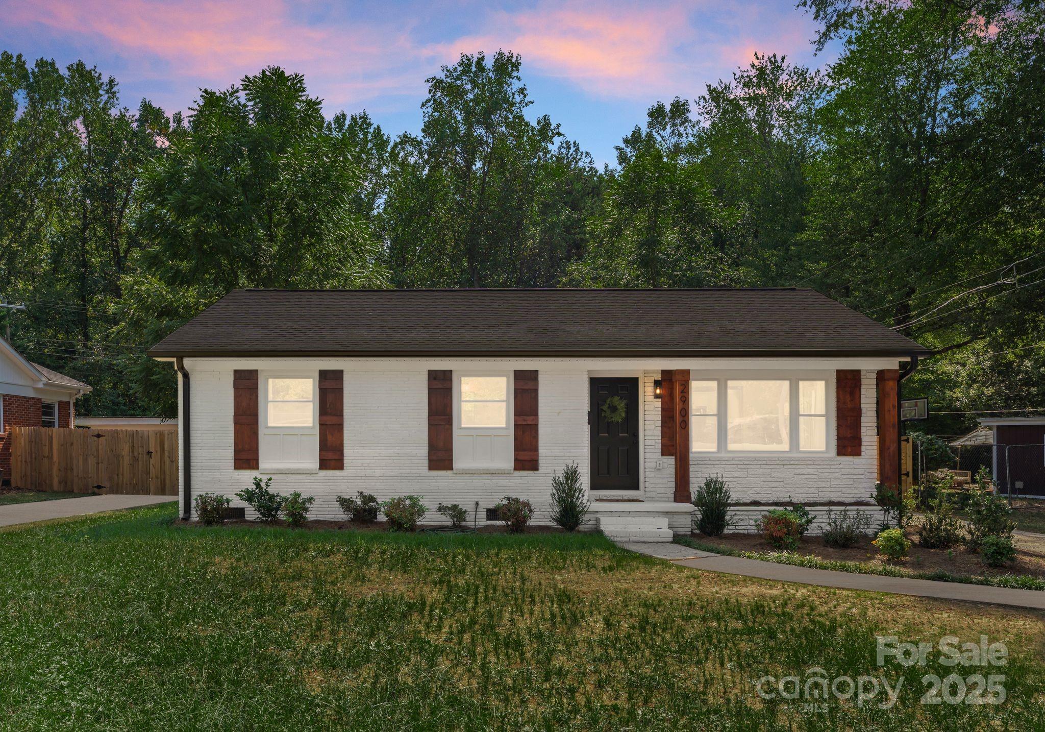 2900 Enfield Road Charlotte, NC 28205 - Photo 32 of 35 a front view of house with yard and trees in the background