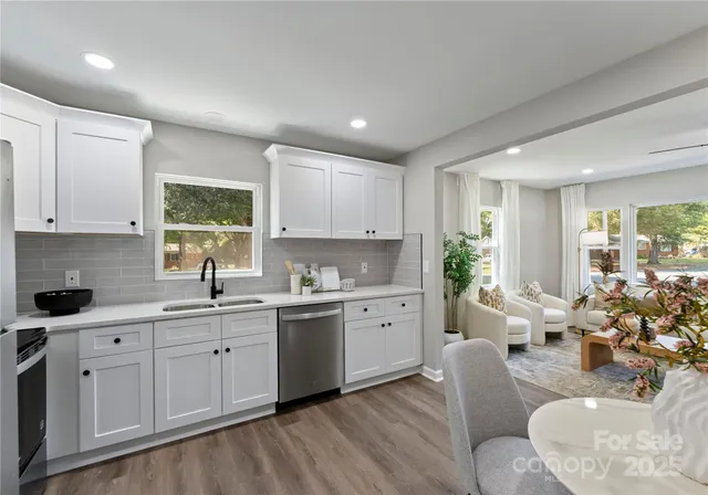 a kitchen with sink stove and cabinets