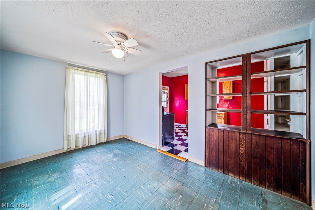 116 South Cedar Street Geneva, OH 44041 - Photo 6 of 35 Tiled dining room featuring ceiling fan and a textured ceiling