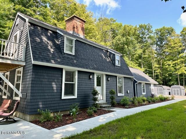 2631 Hancock Road Hancock, MA 01267 - Photo 2 of 55 a front view of a house with a yard and porch