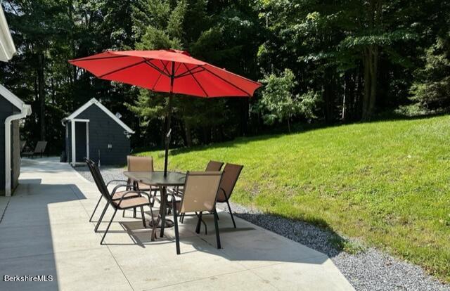 2631 Hancock Road Hancock, MA 01267 - Photo 8 of 55 a view of a patio with a table and chairs under an umbrella