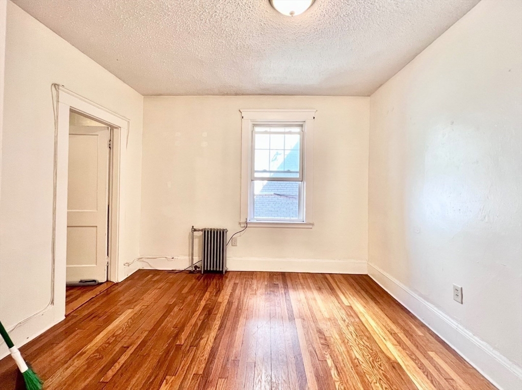 26 Chiswick Road, Unit 6 Boston, MA 02135 - Photo 15 of 24 a view of empty room with wooden floor