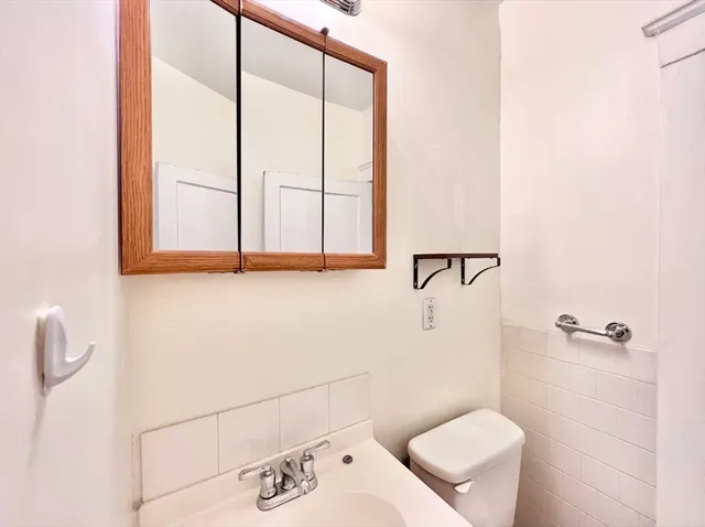 a bathroom with a toilet sink and shower