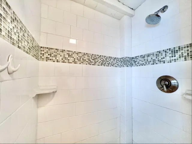 a bathroom with a shower and a sink