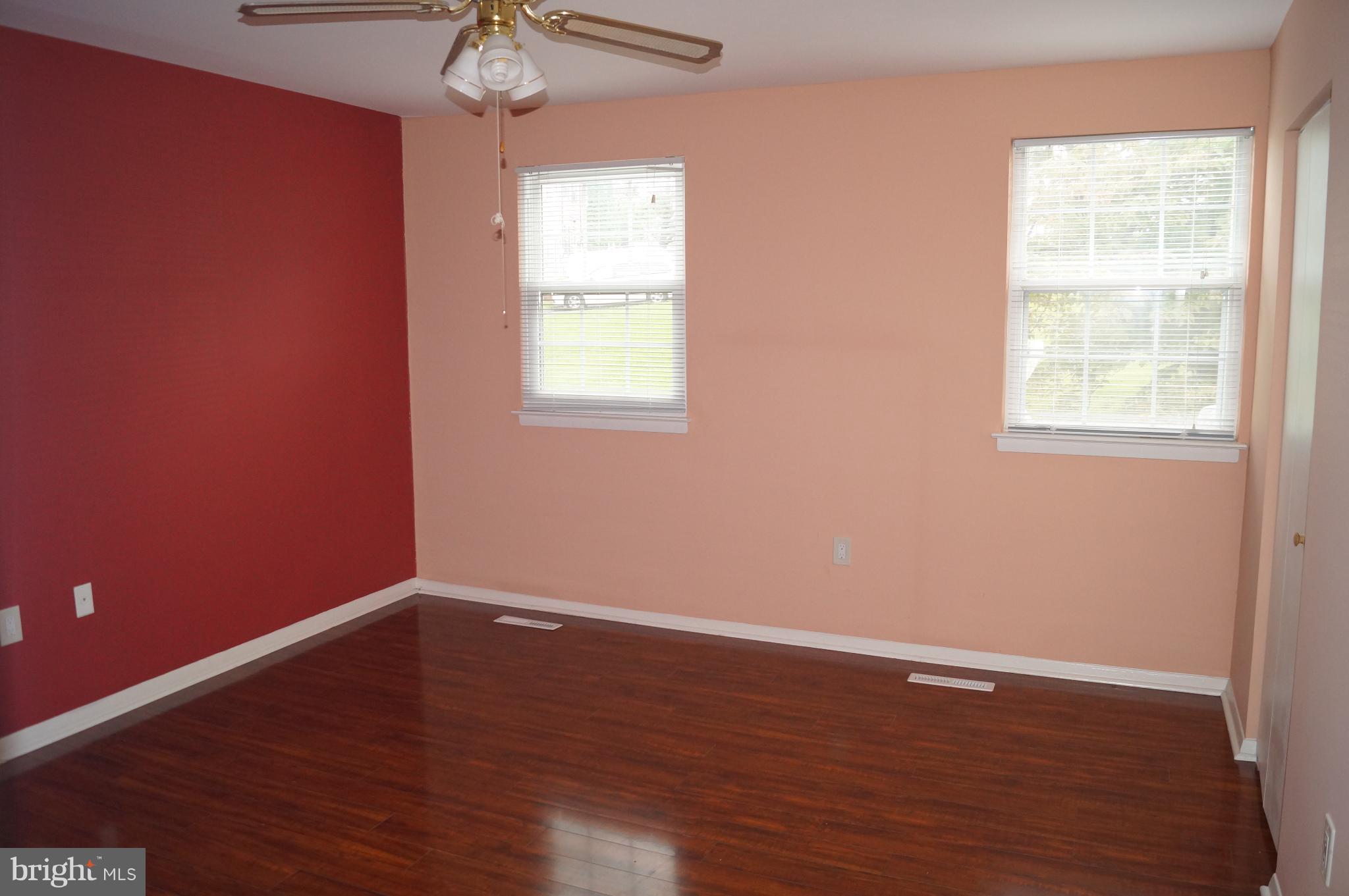 42 Ritters Ridge Court Owings Mills, MD 21117 - Photo 8 of 12 an empty room with wooden floor and windows