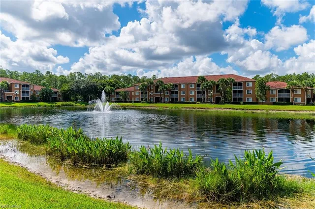 a view of a lake with a house in the background