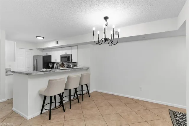 a kitchen with stainless steel appliances a sink and cabinets