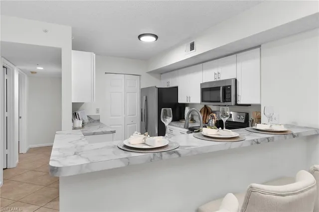 a kitchen with a sink stove and microwave