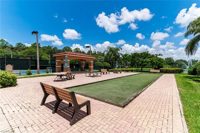 a view of a fountain in front of house with yard