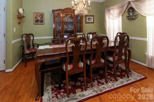 a view of a dining room with furniture and chandelier