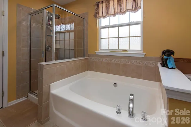a bathroom with a tub and window