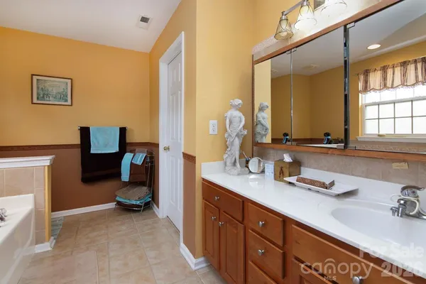 a spacious bathroom with a double vanity sink and a mirror