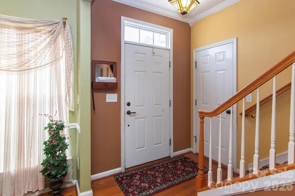 a view of entryway with wooden floor and front door