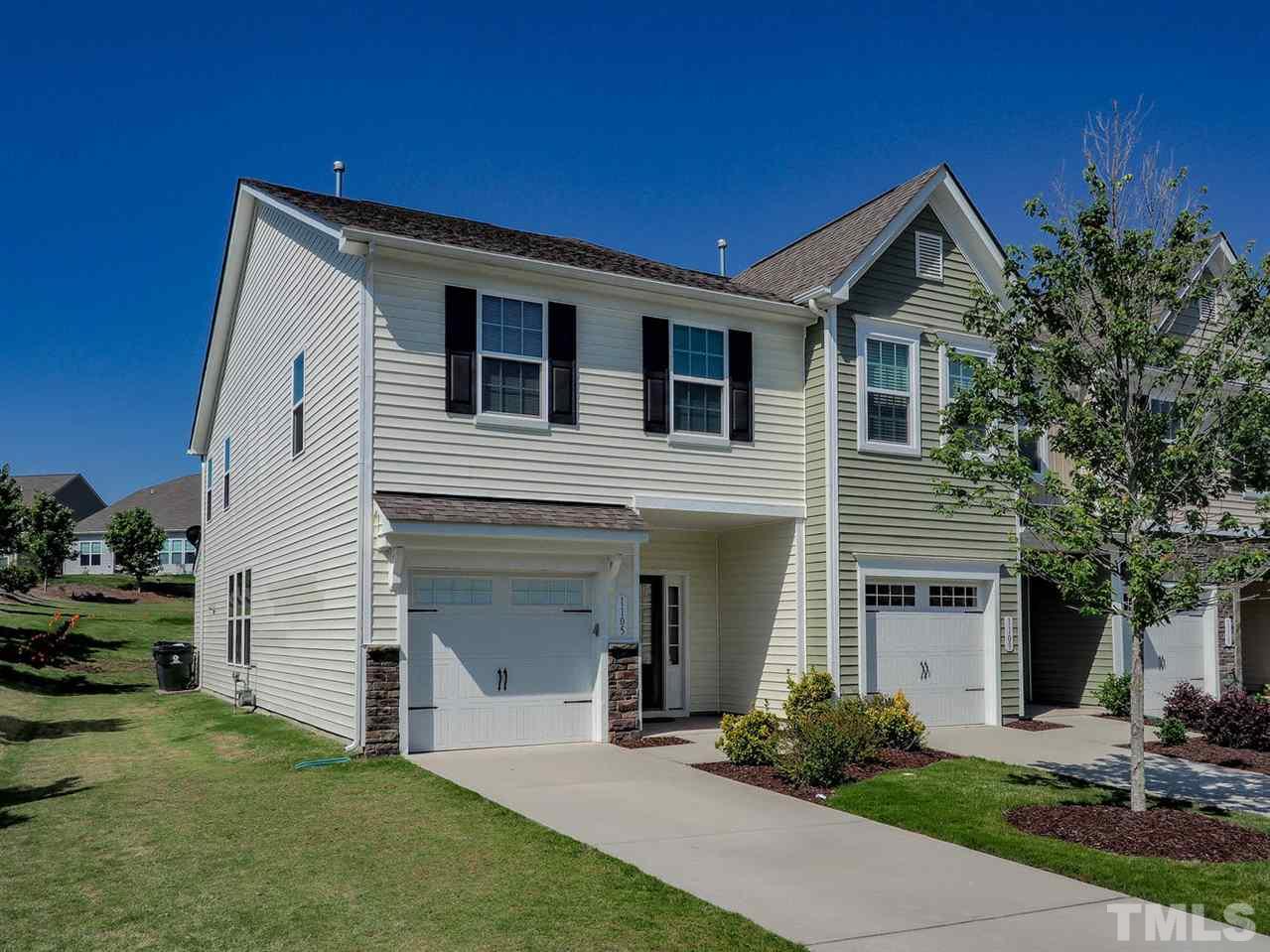 1105 Falcon Ridge Lane Morrisville, NC 27560 - Photo 1 of 22 a front view of a house with a yard and garage