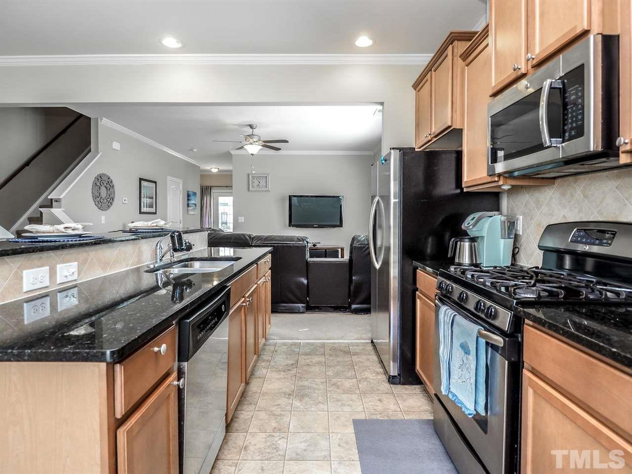 1105 Falcon Ridge Lane Morrisville, NC 27560 - Photo 12 of 22 a kitchen with stainless steel appliances granite countertop a stove a sink and a microwave