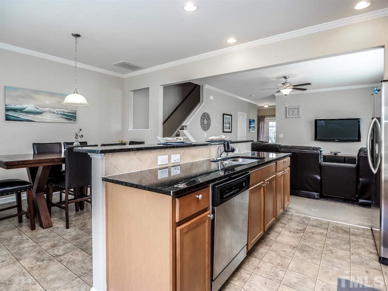 1105 Falcon Ridge Lane Morrisville, NC 27560 - Photo 13 of 22 a kitchen with stainless steel appliances granite countertop a stove and a sink
