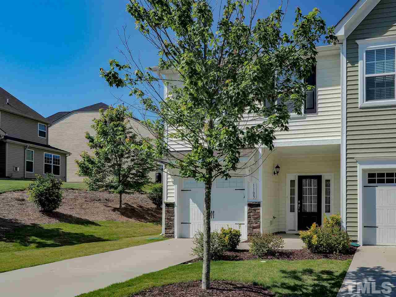 1105 Falcon Ridge Lane Morrisville, NC 27560 - Photo 3 of 22 a front view of a house with a garden