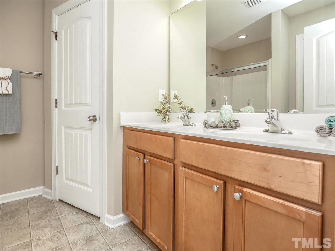 1105 Falcon Ridge Lane Morrisville, NC 27560 - Photo 21 of 22 a bathroom with a double vanity sink and a mirror