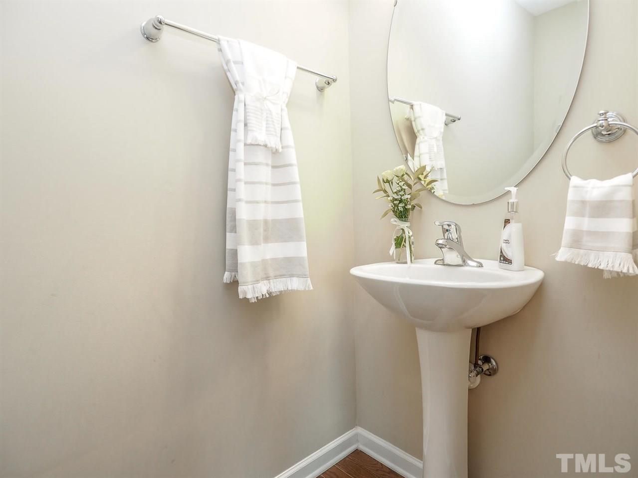1105 Falcon Ridge Lane Morrisville, NC 27560 - Photo 5 of 22 a bathroom with a sink a mirror and a shower