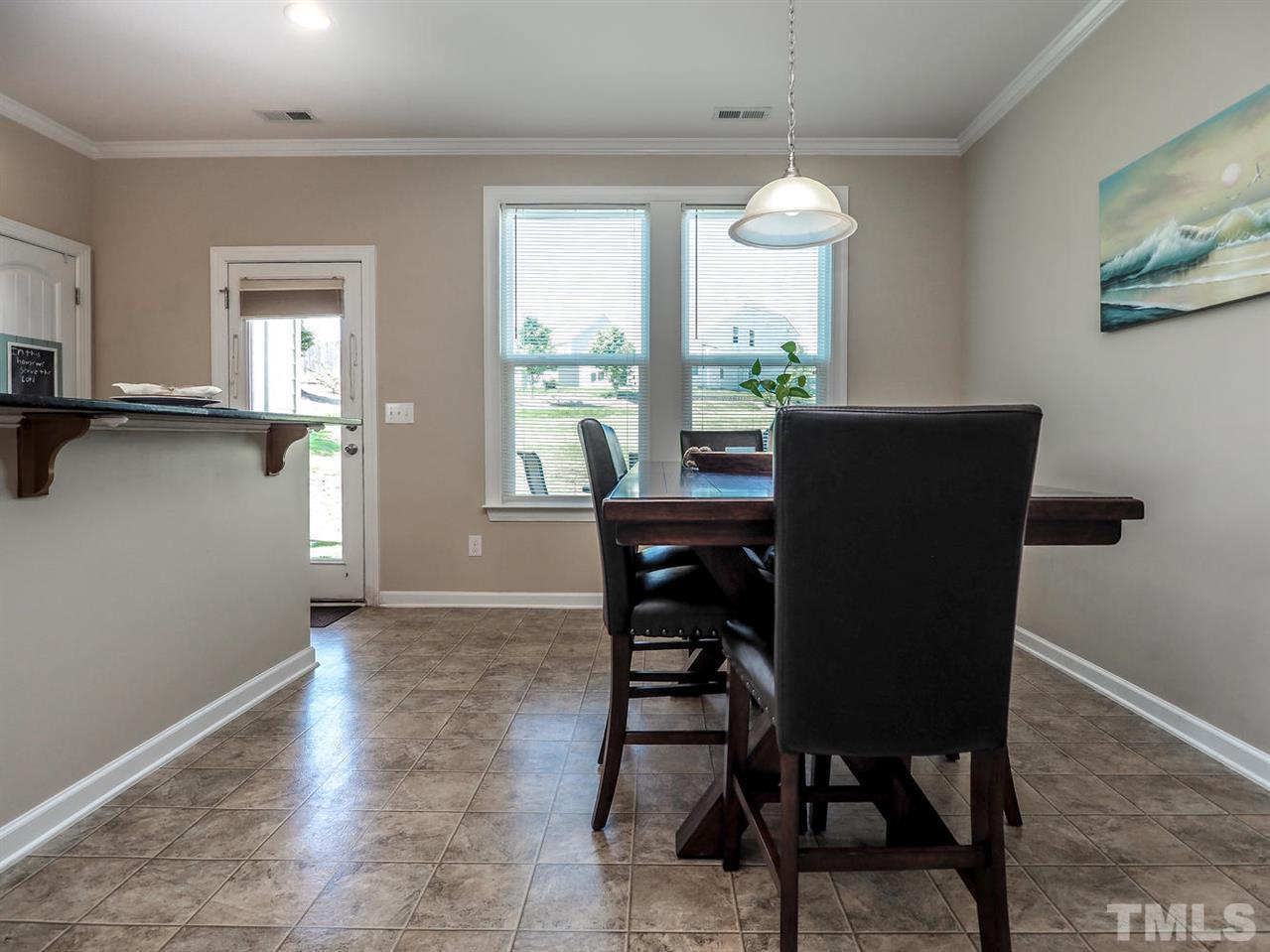 1105 Falcon Ridge Lane Morrisville, NC 27560 - Photo 9 of 22 a view of a dining room with furniture window and wooden floor