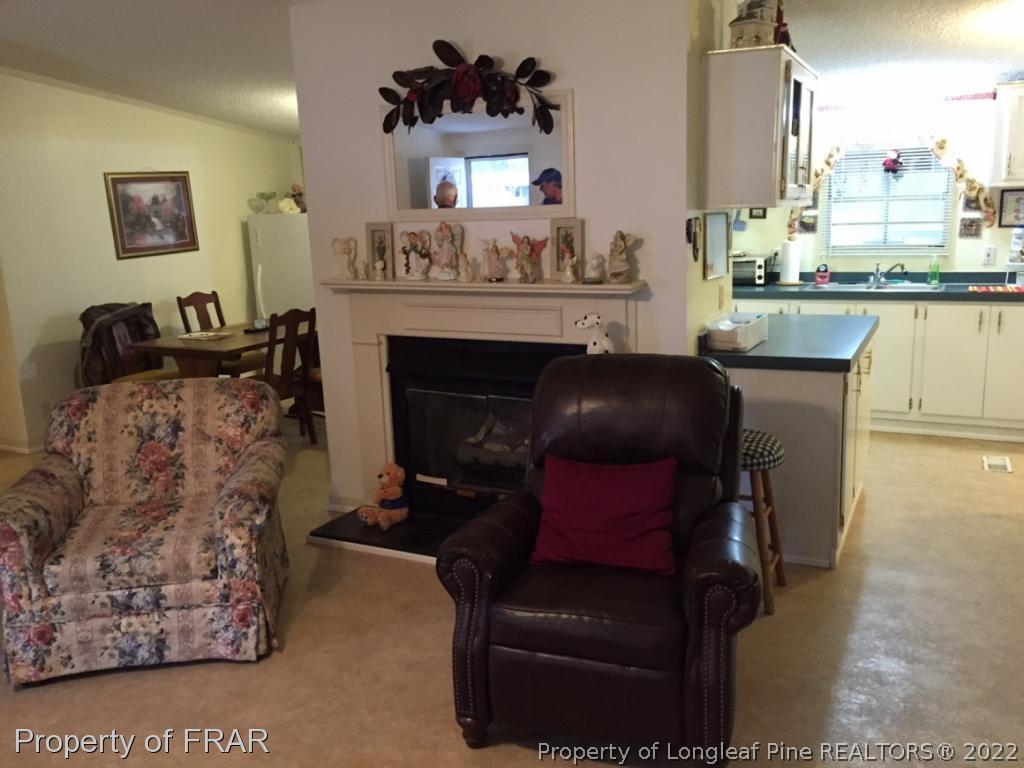 2311 Calloway Road Raeford, NC 28376 - Photo 3 of 13 a living room with furniture and a fireplace