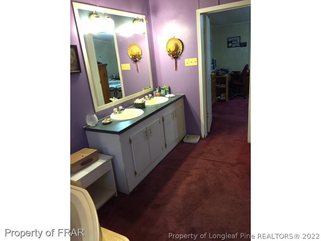 2311 Calloway Road Raeford, NC 28376 - Photo 5 of 13 a bathroom with a sink and a mirror