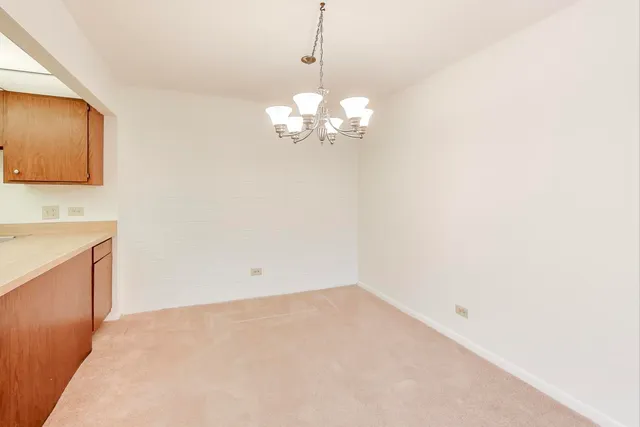 a view of a room with a chandelier fan and a large window