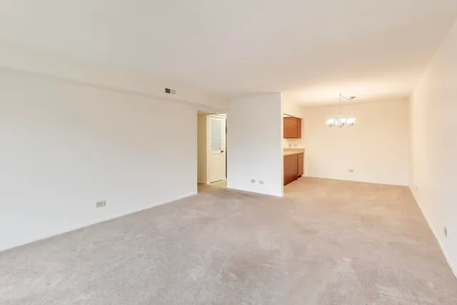 a view of a chandelier in a room and a cabinet