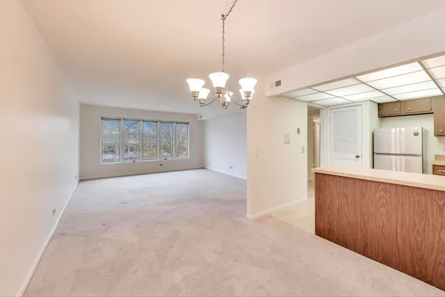 a kitchen with stainless steel appliances granite countertop a sink a stove and refrigerator