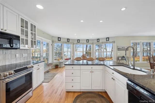 a large white kitchen with a large window