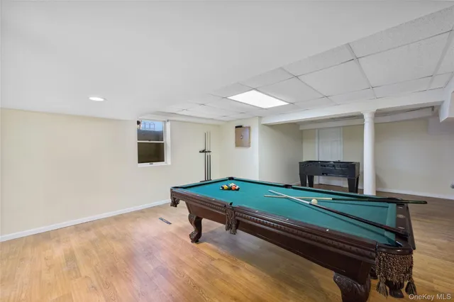 a room with furniture pool table flat screen tv and pool table
